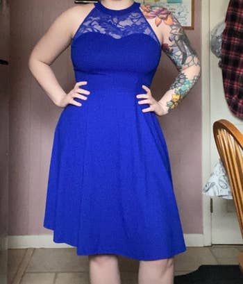 reviewer wearing a blue dress