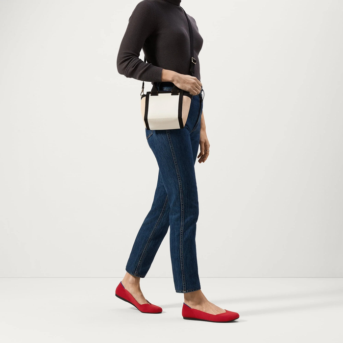 model wearing the bright red flats styled with jeans