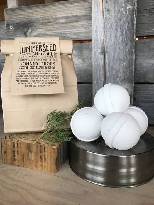 A bag of toilet bombs positioned next to several individual toilet bombs.