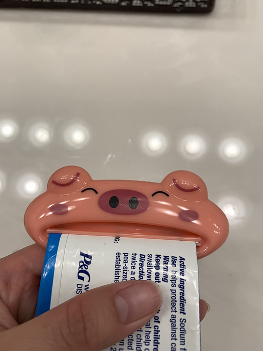 A customer using the tube squeezer on a toothpaste tube