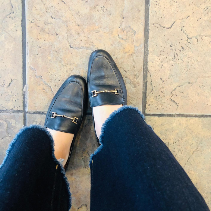 reviewer wearing the black loafers