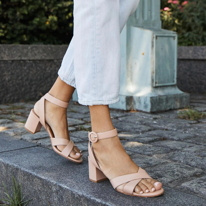 model showcasing the beige sandals on their feet