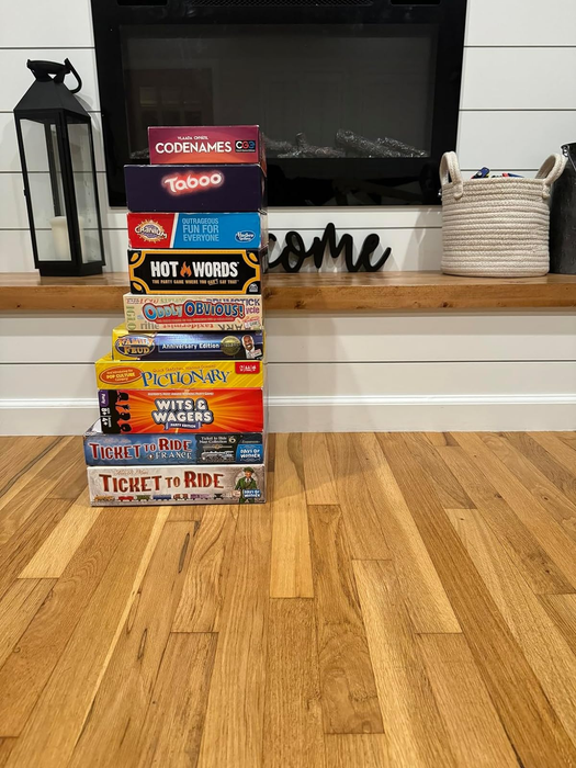A collection of various family board games such as Codenames, Taboo, Hot Words, Oddly Obvious, Pictionary, Wits & Wagers, and Ticket to Ride