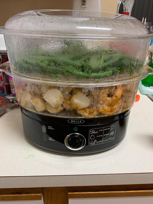 A reviewer's photo of the two-tier steamer filled with green beans and shrimp.