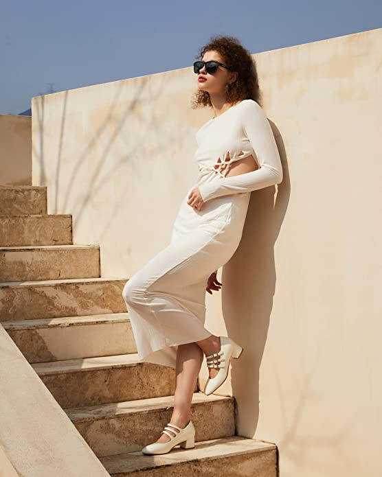 the same model wearing the white version of the heels