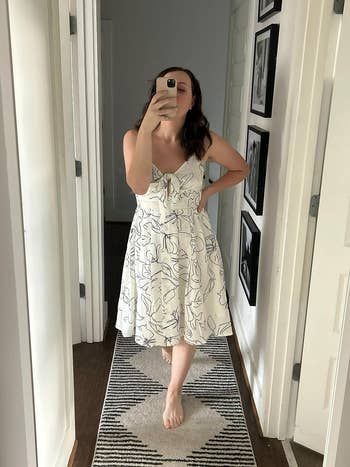 reviewer wearing a soft apricot dress