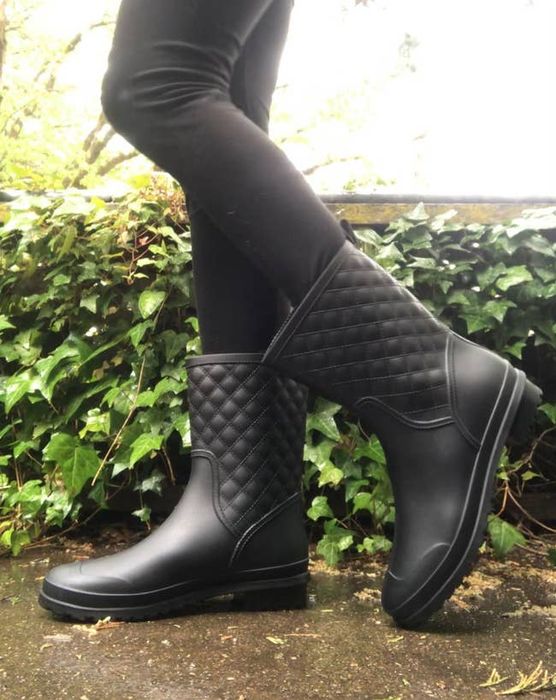 a reviewer showcasing black waterproof boots