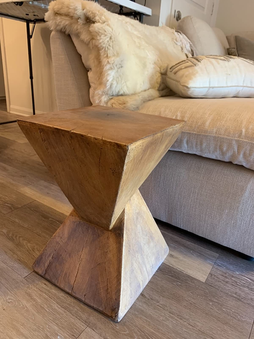 Close-up of the end table placed next to an armchair.