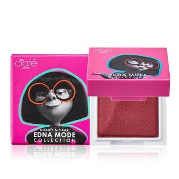 A pink square lip powder featuring Edna Mode's image on the front of the packaging.