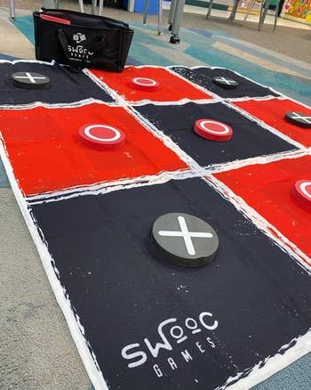 A large tic-tac-toe game featuring bold red and black squares for an oversized gaming experience.