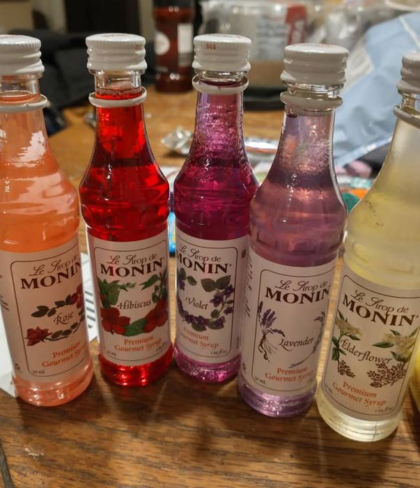 Images from reviewers showcasing various flavored syrup bottles