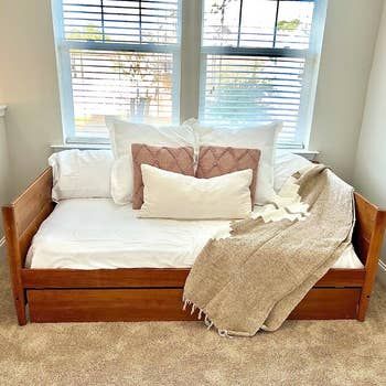 reviewer photo showing a wooden daybed