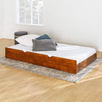 Image of the individual trundle bed, showcasing its simple design and functionality.