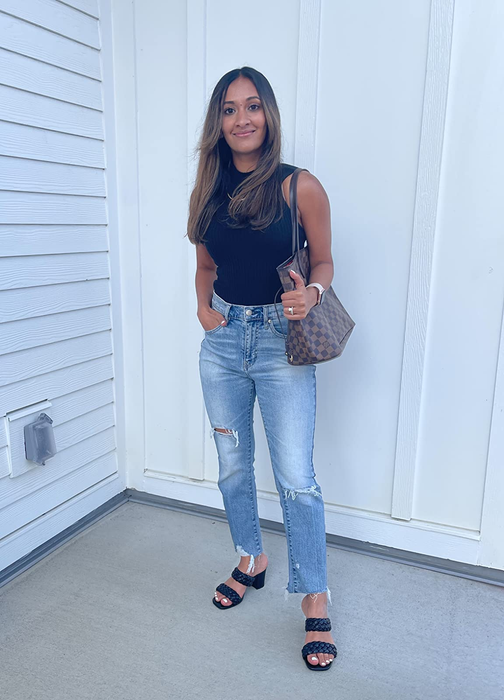 full-length view of a reviewer wearing the black sandals