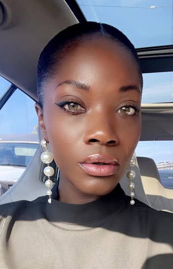 A reviewer pairs the earrings with a sleek black turtleneck for a chic look.
