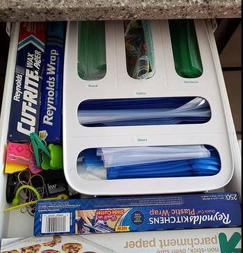 The same dispenser, now enhanced with stickers labeling each bag size for easy identification.