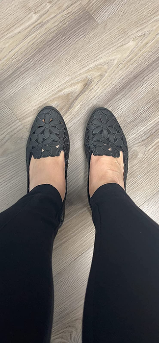 reviewer showcasing the black flats