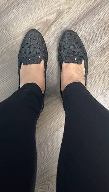 reviewer showcasing the black flats