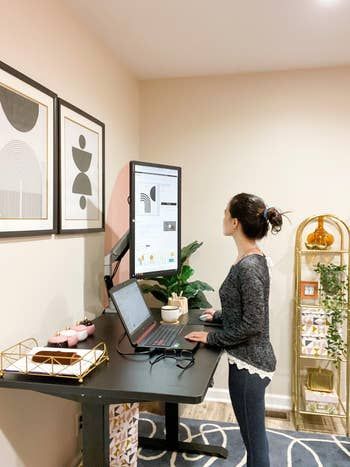 another reviewer standing at their black desk