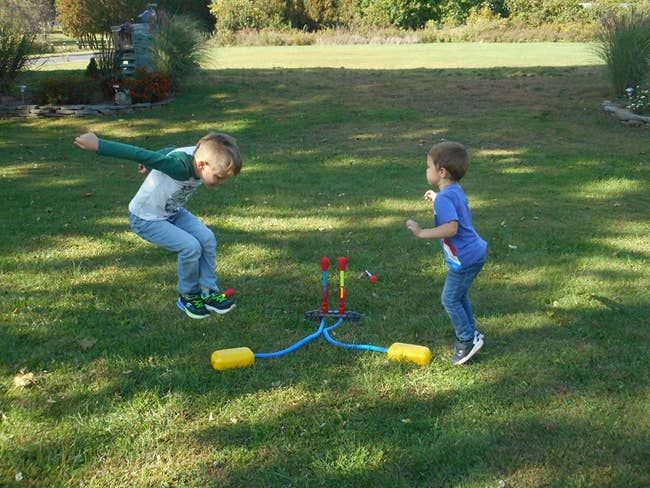 A reviewer's two children having fun jumping on the rocket launcher
