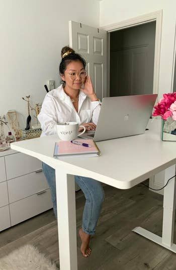a reviewer standing and working at the desk
