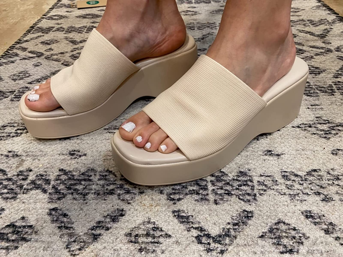 a reviewer wearing the sandals in cream
