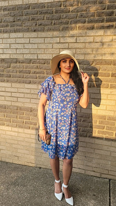 reviewer wearing the white pumps paired with a dress