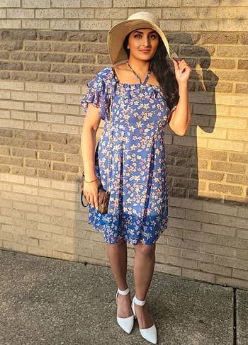 reviewer wearing the white pumps paired with a dress