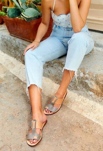 a model wearing the gray and tan shoes