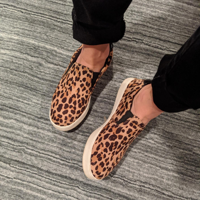 reviewer wearing the leopard print Dr. Scholl's sneakers