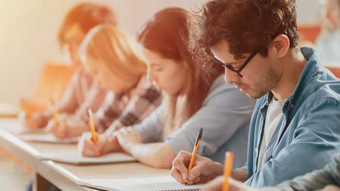A group of university students taking an exam