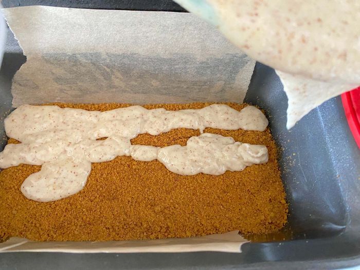 Gently pour the remaining batter over the middle layer of cookie crumbs in your loaf pan.
