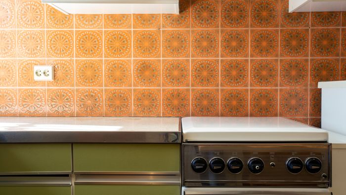 a retro 1970s kitchen countertop with a range
