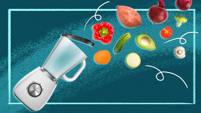 A visual of a food processor with the lid open and vegetables flying out of it