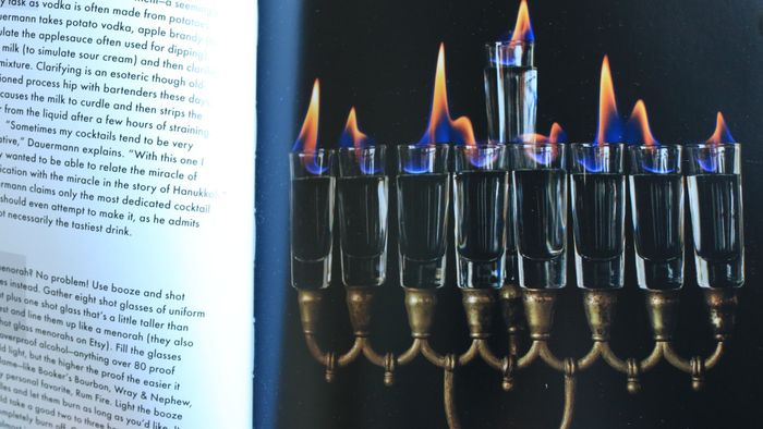 A menorah crafted from flaming shot glasses featured in the cookbook.