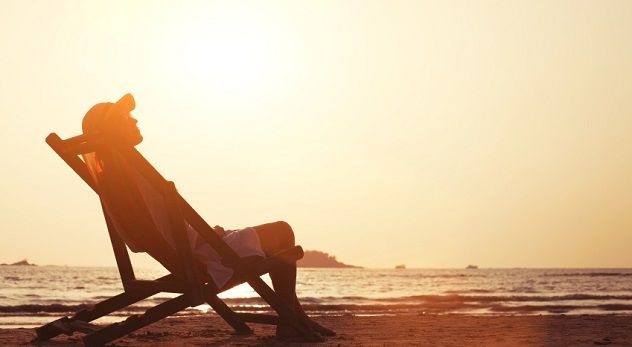 young woman enjoying sunset on the tropical beach