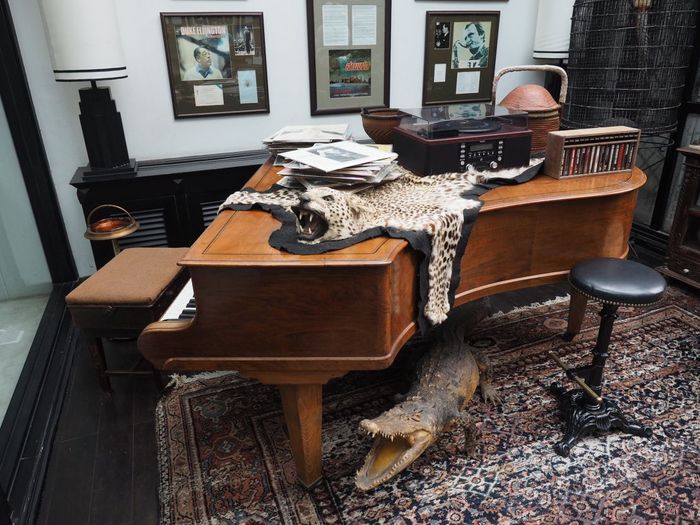 Leopard perched atop a piano in The Siam's Vinyl Room.