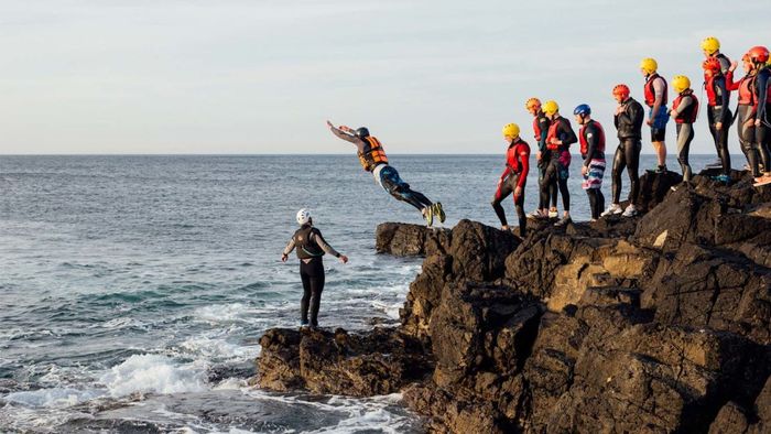 Leaping into the Atlantic along Northern Ireland's rugged coastline.