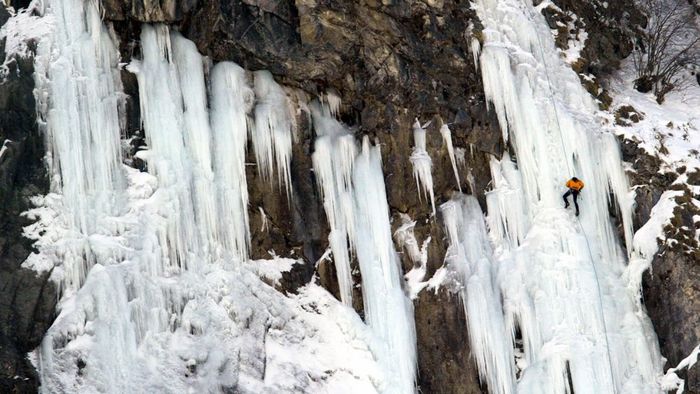 A climber rappels down a frozen waterfall in France's Cirque de Gavarnie, located in the Pyrenees.