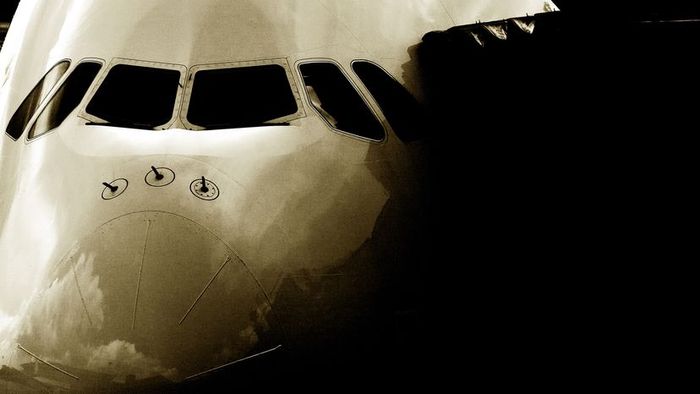 A commercial airplane linked to a jet bridge for passenger boarding