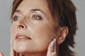 a woman inspecting her facial skin