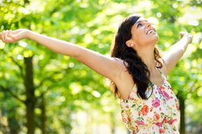 A woman lifting her arms confidently