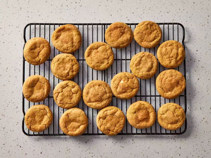 Pumpkin cheesecake cookies cooling on a wire rack, ready to enjoy.