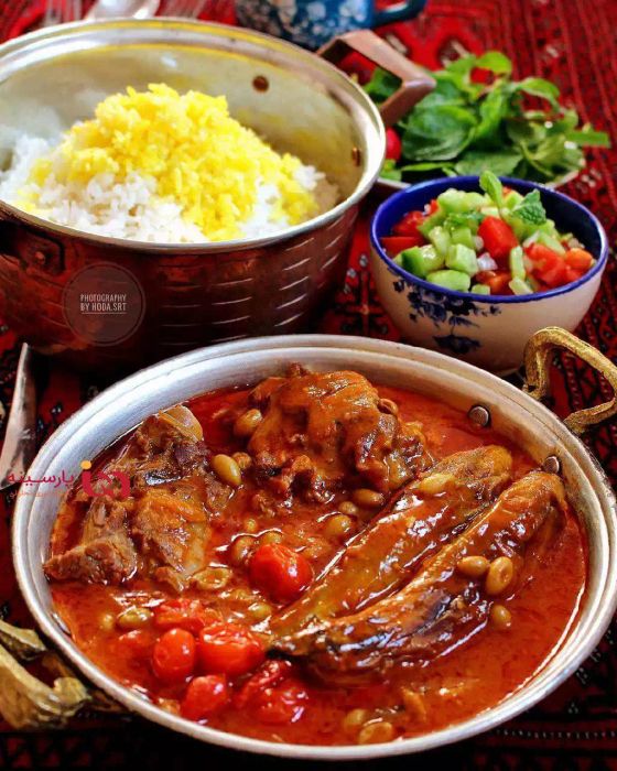 Khoresht Bademjoumn: an eggplant stew served with Shirazi salad and vegetables