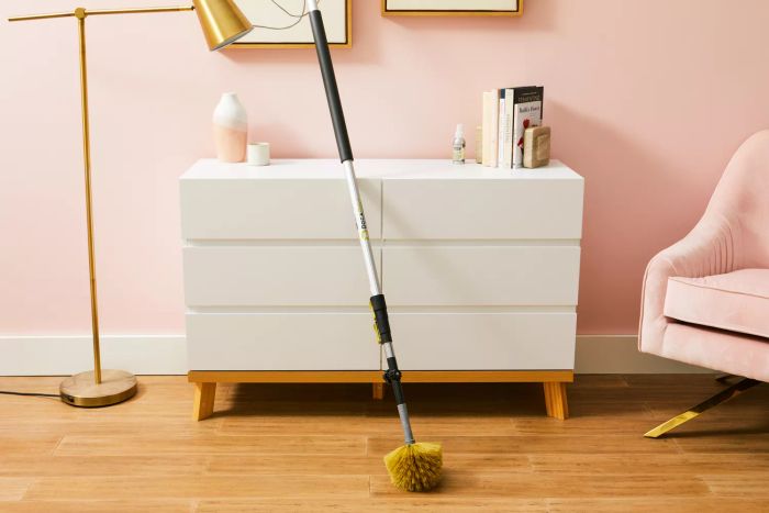 The DocaPole Microfiber Duster with Extension Pole rests against a dresser.