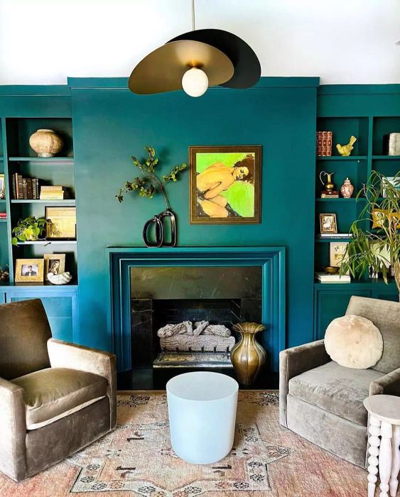 A blue fireplace mantel adorned with a distinctive vase.