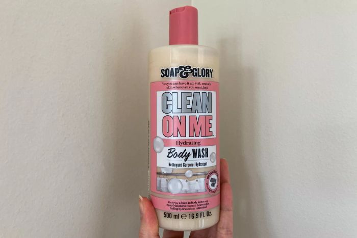 A person holding the Soap & Glory Clean on Me Body Wash