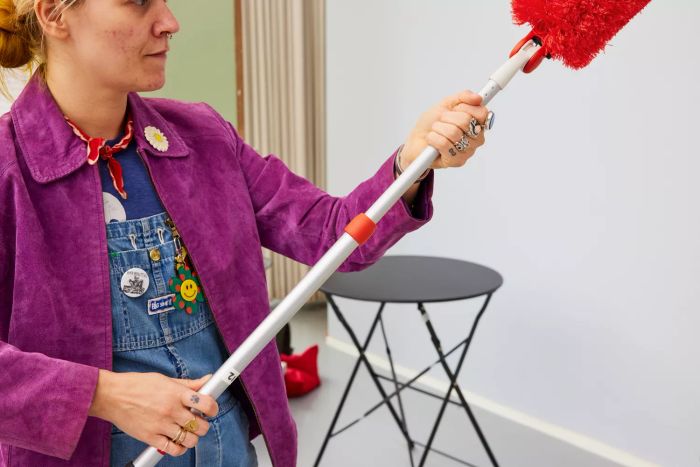 An individual assembles the OXO Good Grips Microfiber Extendable Duster.