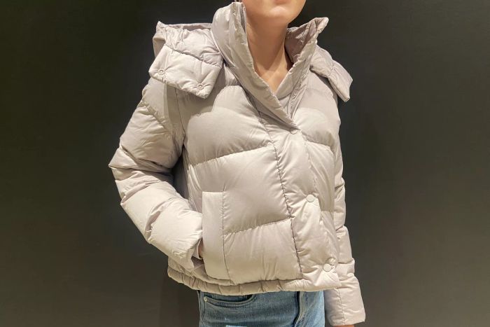 A woman sporting the lululemon Wunder Puff Cropped Jacket, with her hand casually tucked into the pocket