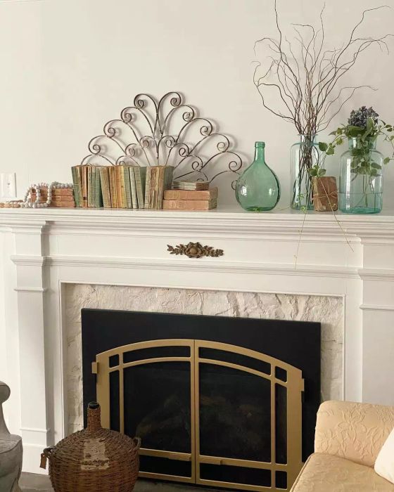 A collection of transparent vases resting on the mantel.